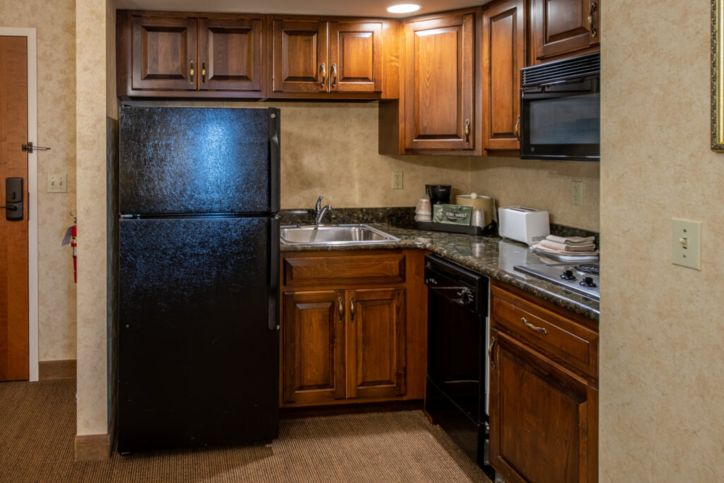 kitchenette with microwave, refrigerator, coffee make, and sink in our 1 & 2 Bedroom Suites