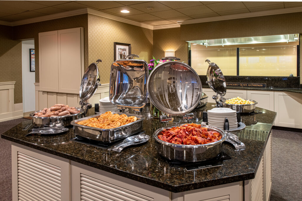 complimentary breakfast buffet with sausage links, waffles, bacon, eggs and more setup