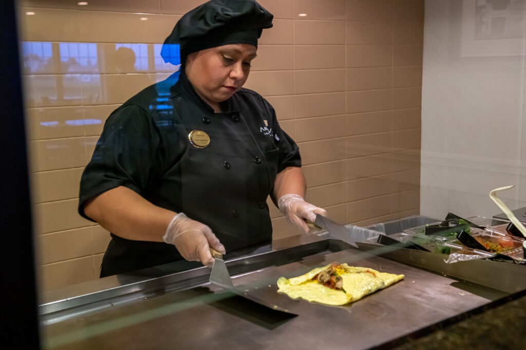 cook making an omelet for our complimentary breakfast buffet