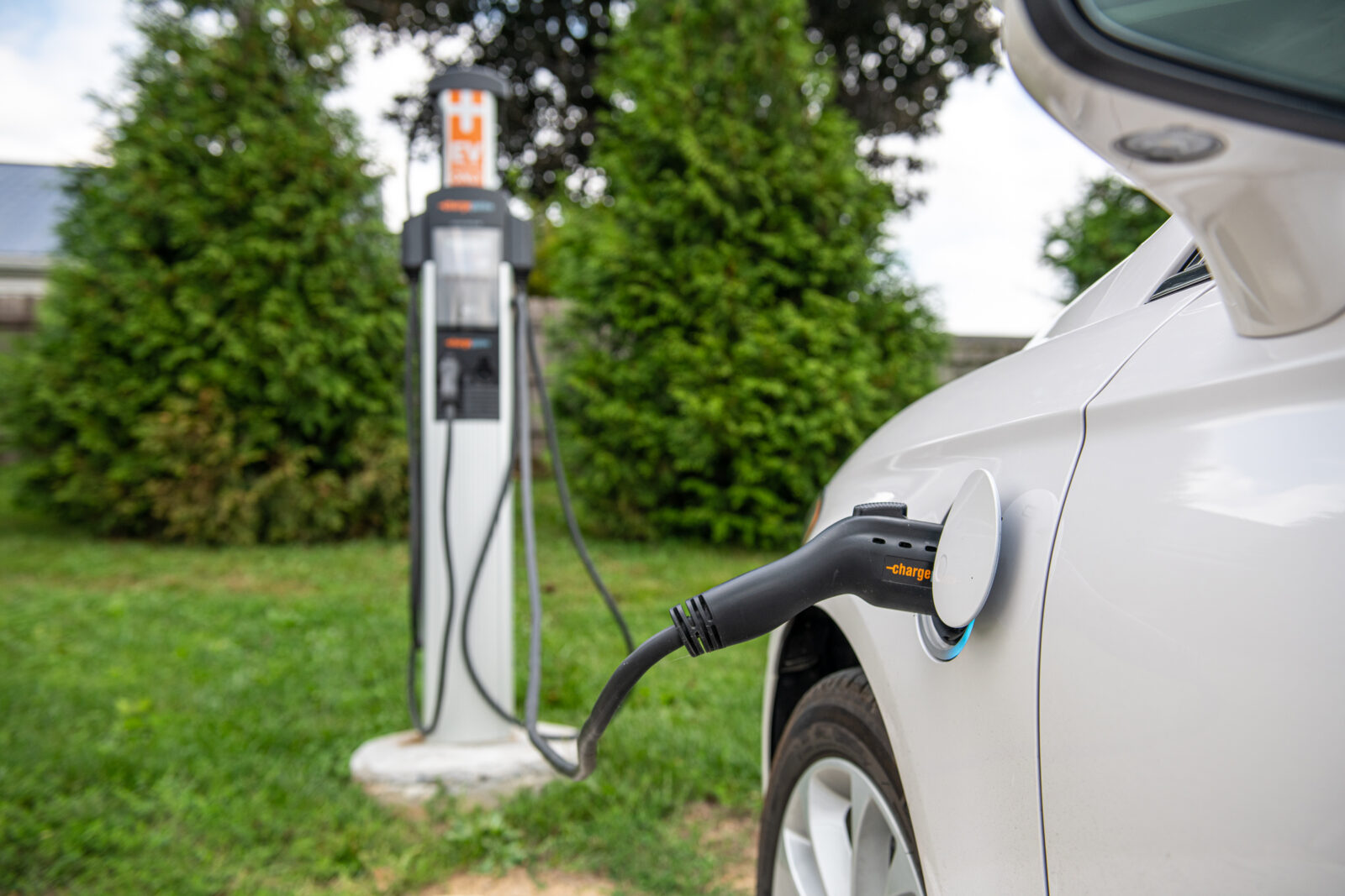 electric car charging station plugged into an electric vehicle