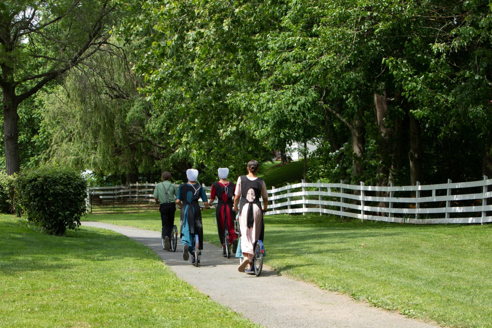 Amish Youth in Traditional Clothing on Scooters